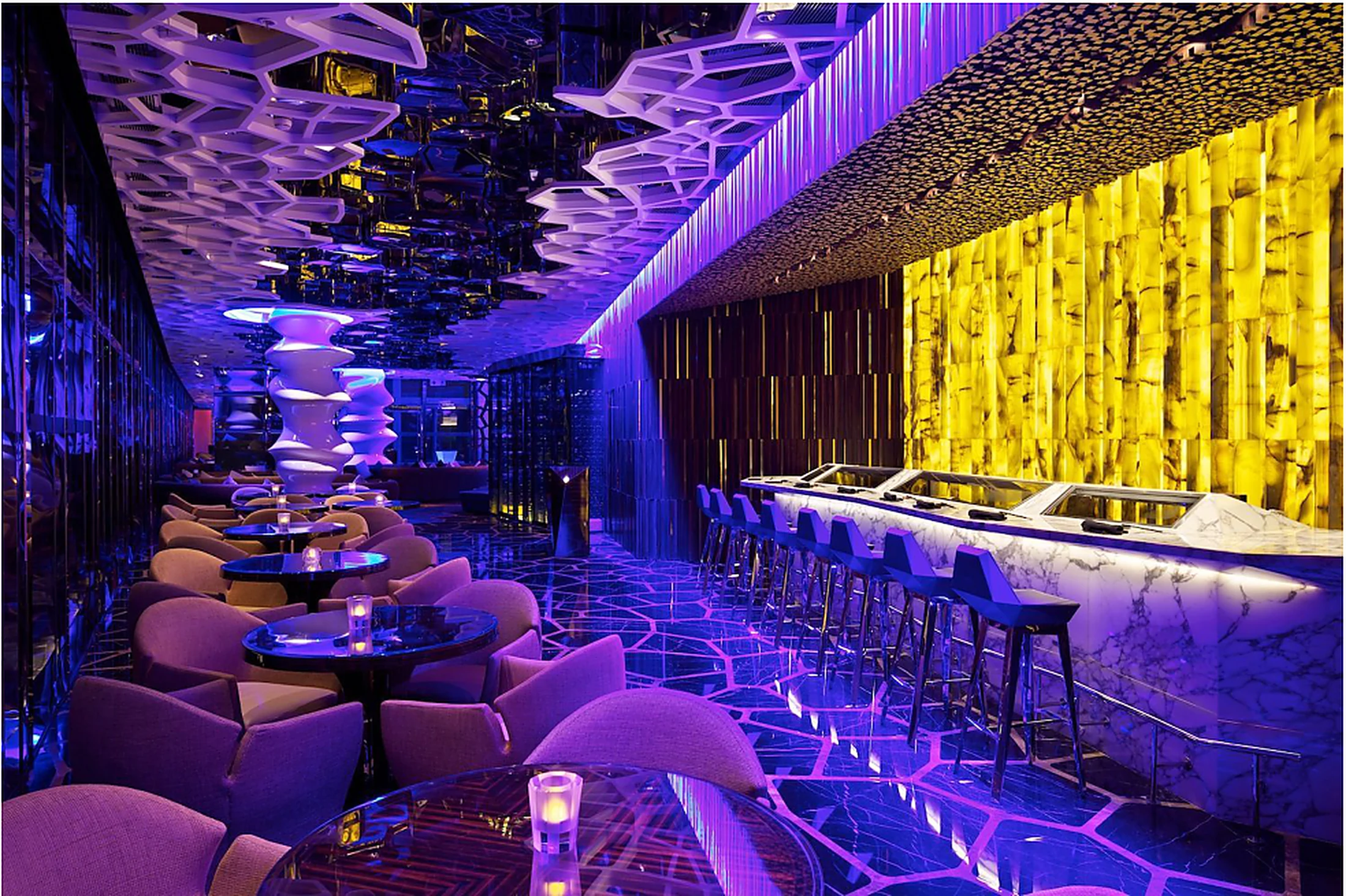 Guests sharing cocktails and conversation in a lively restaurant